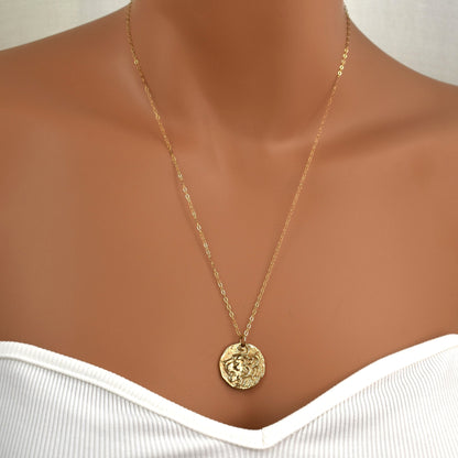 Gold necklace with roaring lion's head pendant shown on model.