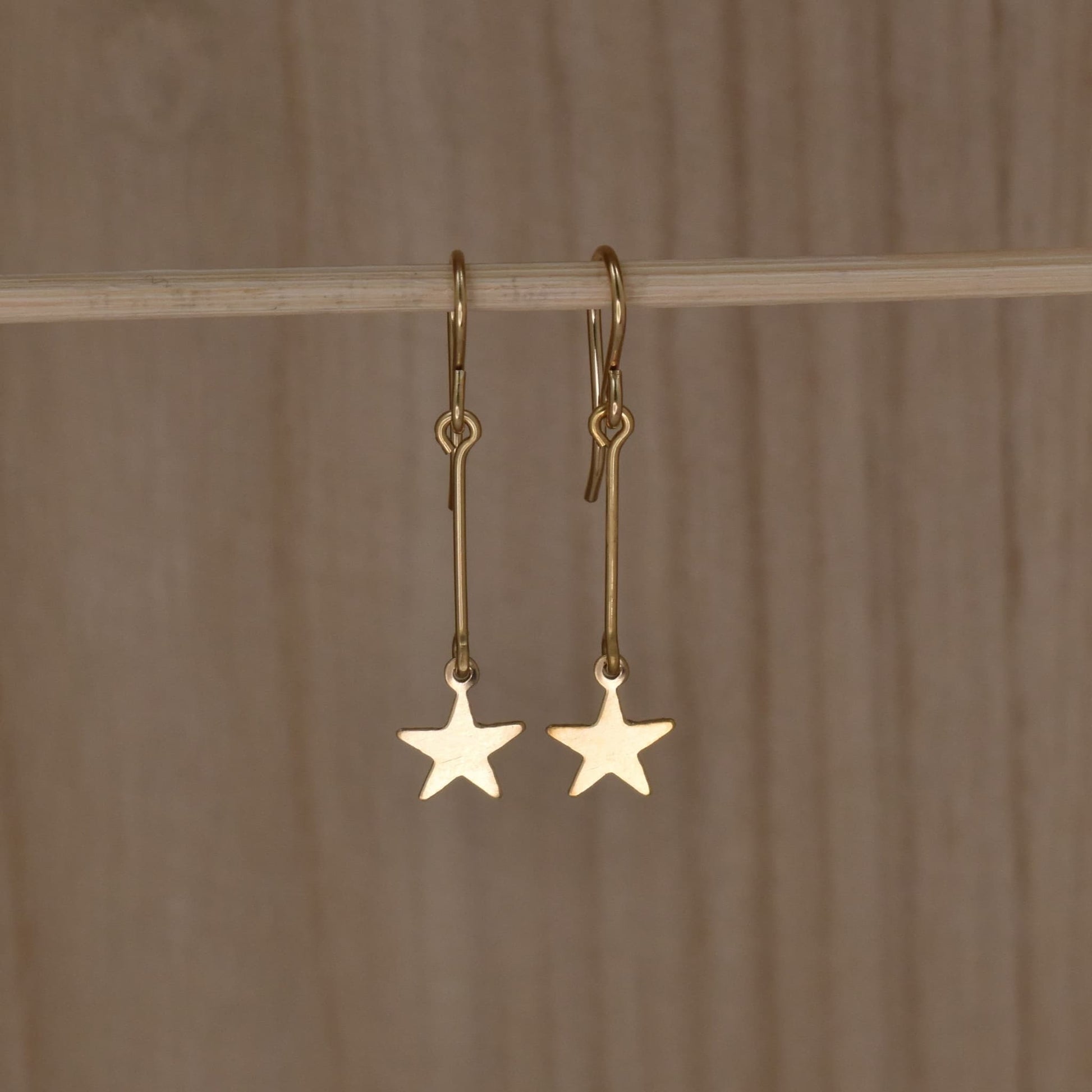 Gold star dangle earrings. Magic wand earrings.