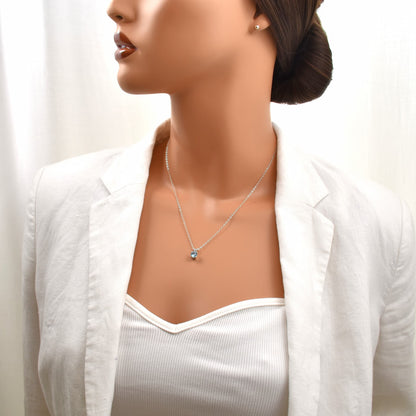 Swiss blue topaz pendant necklace 18 inches on a sterling silver chain shown on a female model.