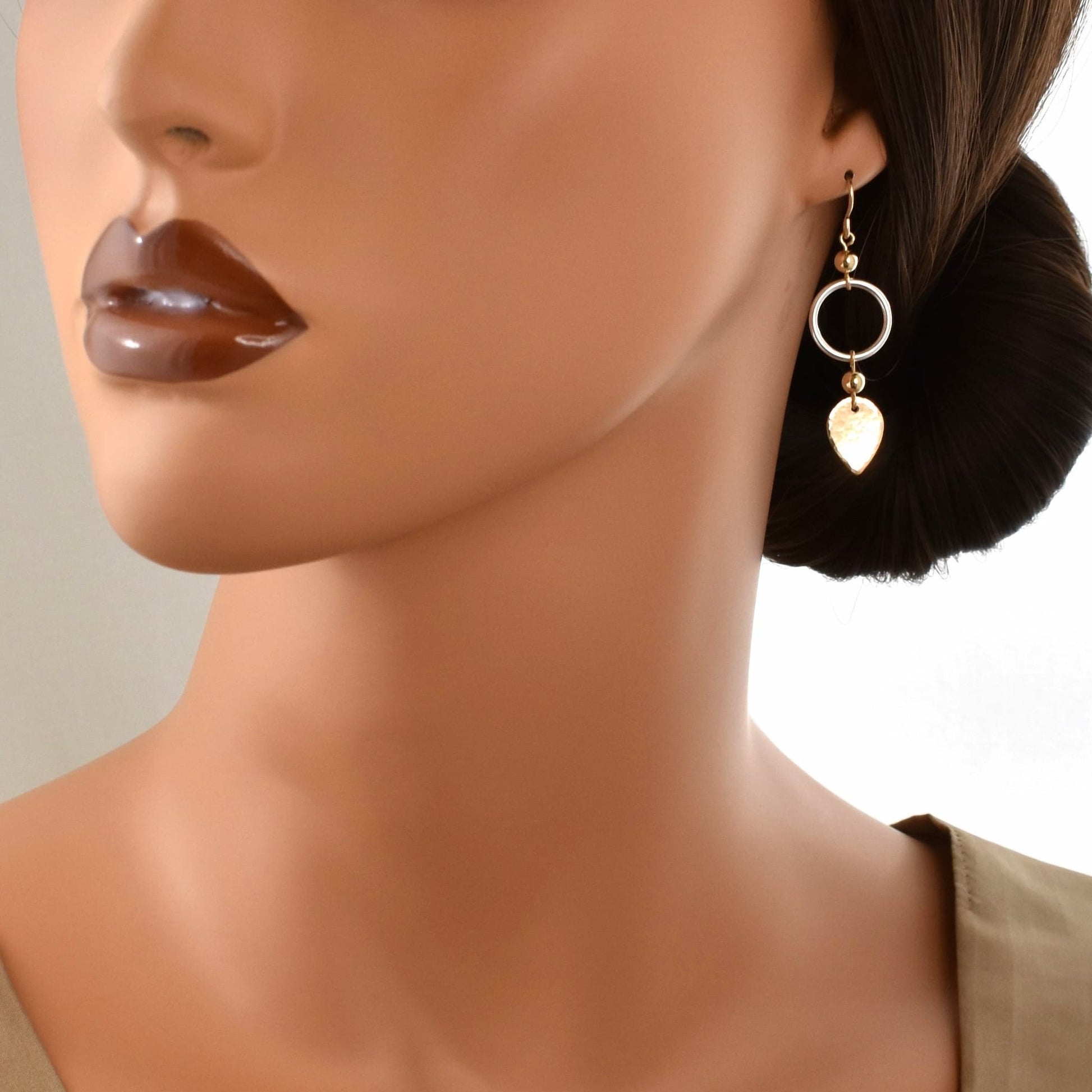 gold and silver boho dangle earrings shown on model.