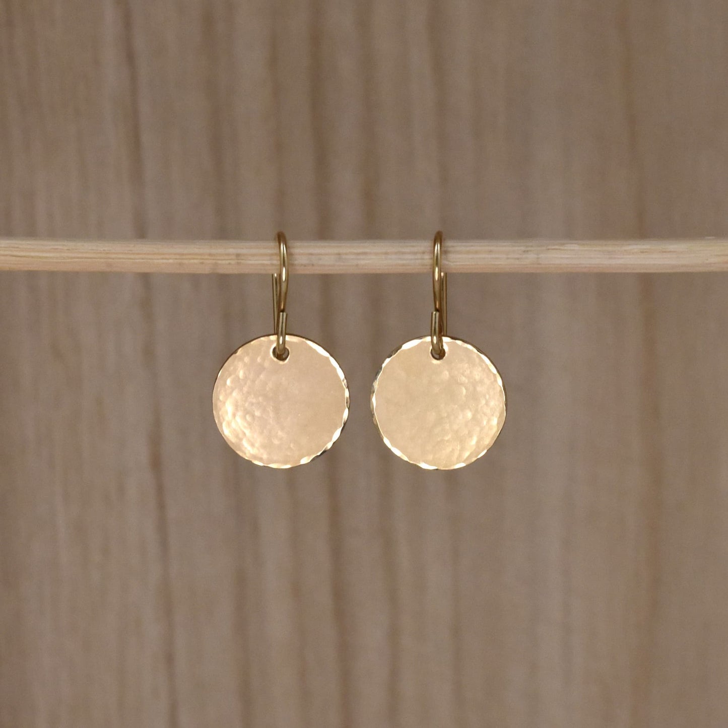 gold circle drop earrings.