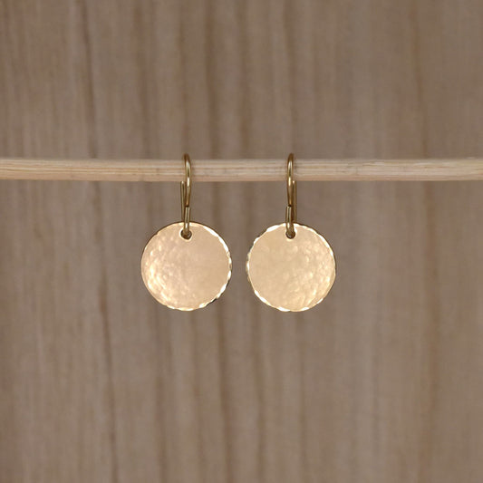 gold circle drop earrings.