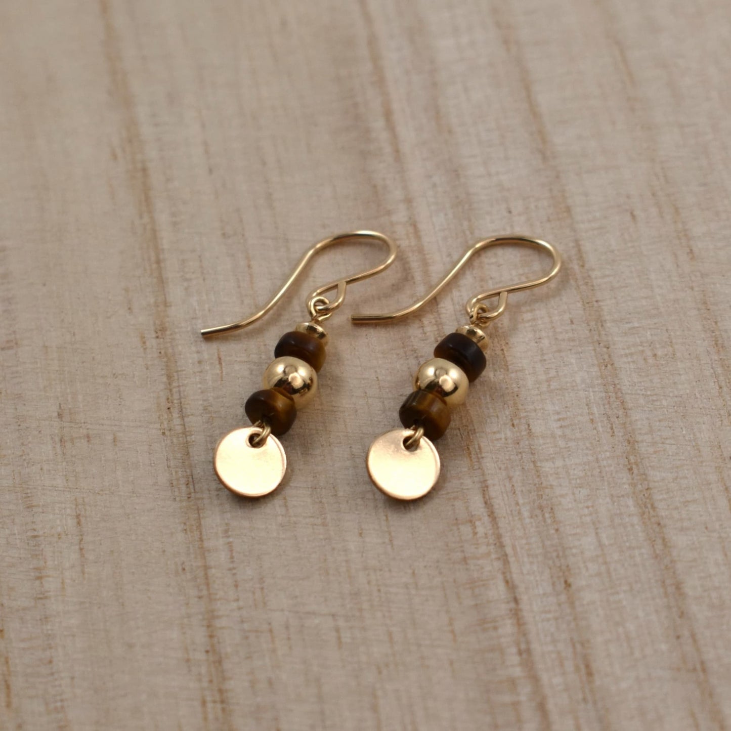 Gold drop earrings with tiger's eye gemstones.