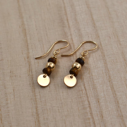 Gold drop earrings with tiger's eye gemstones.