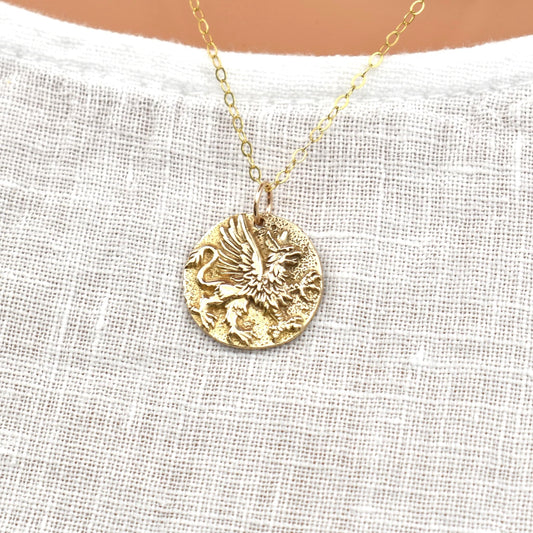 Gold griffin pendant necklace.