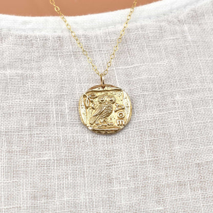 Gold owl pendant necklace with symbol of Greek goddess Athena.