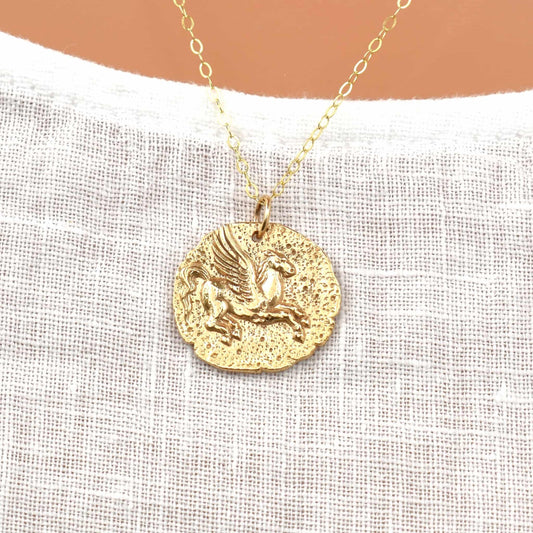 Gold horse pendant necklace showing Pegasus of Greek mythology.