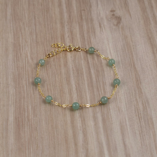 Green aventurine bead bracelet on gold chain.