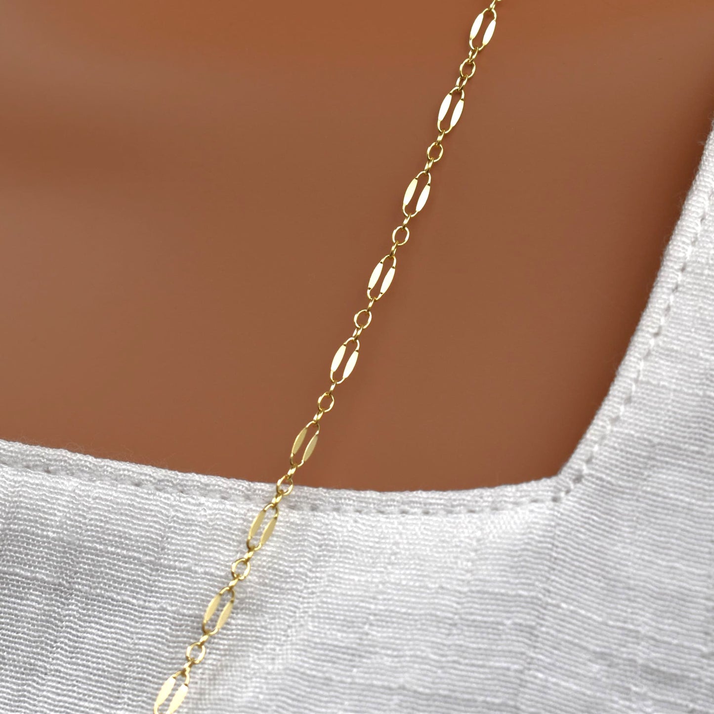 Long gold chain necklace for women close up.