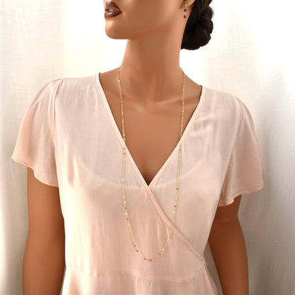 Long gold chain necklace for women on model.