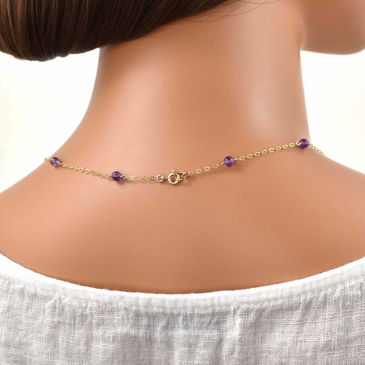 long gold necklace with amethyst beads spring ring clasp.