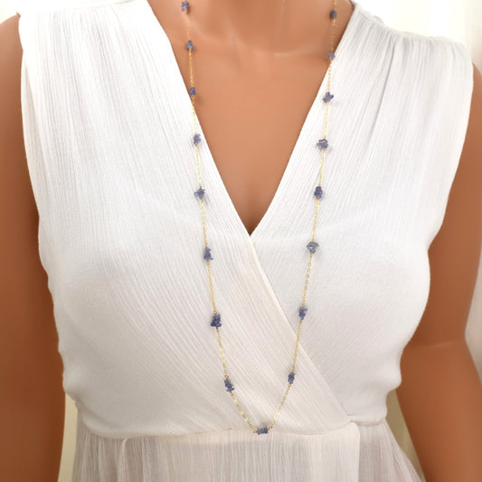 long gold chain necklace with tanzanite chip beads spaced evenly along the chain.