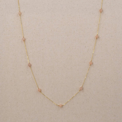 Long gold necklace with pink peach quartz gemstones