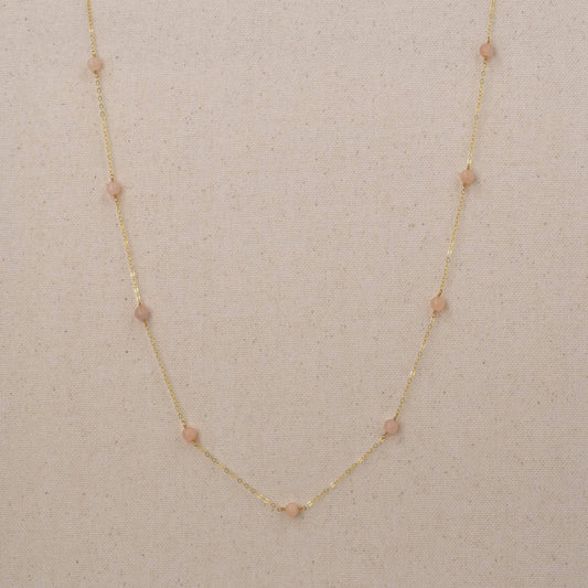 Long gold necklace with pink peach quartz gemstones