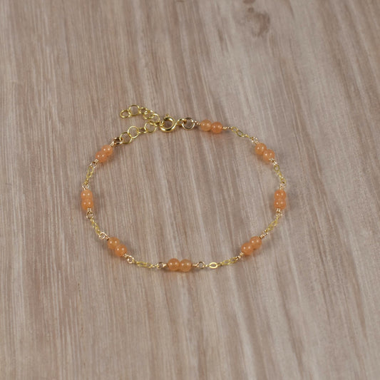 Orange aventurine bead bracelet with gold chain.