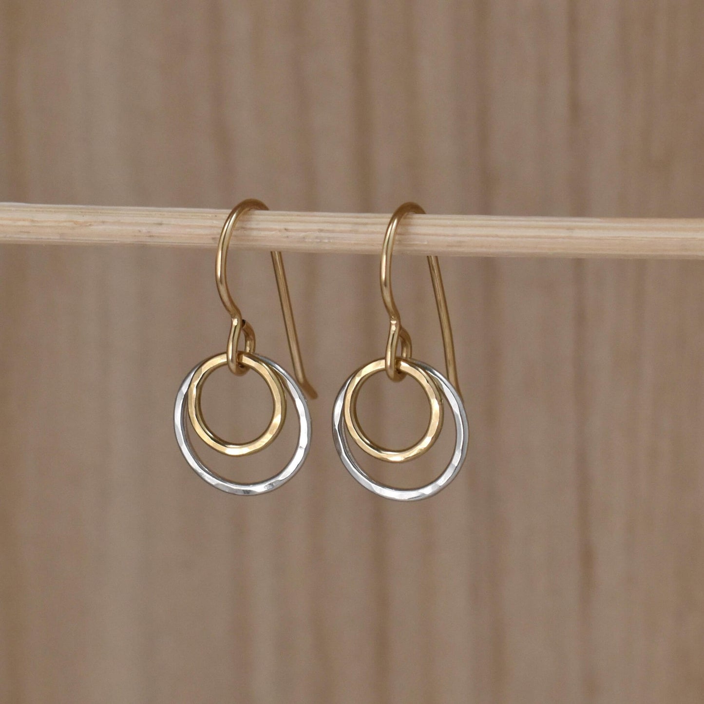 Gold and silver small circle drop earrings.